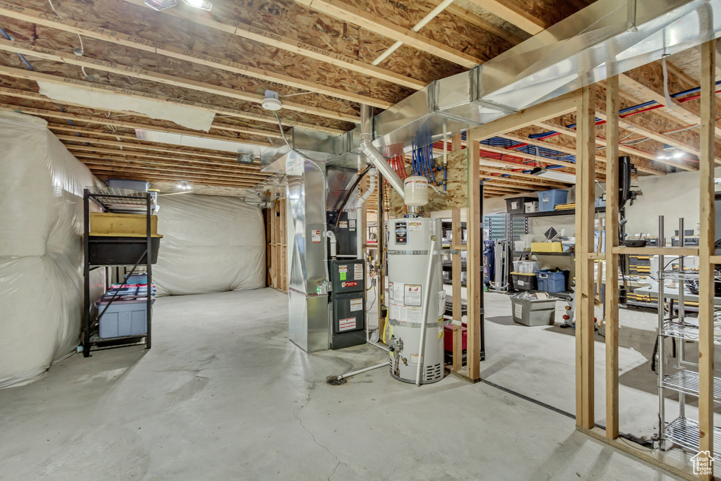 Basement featuring heating utilities and water heater