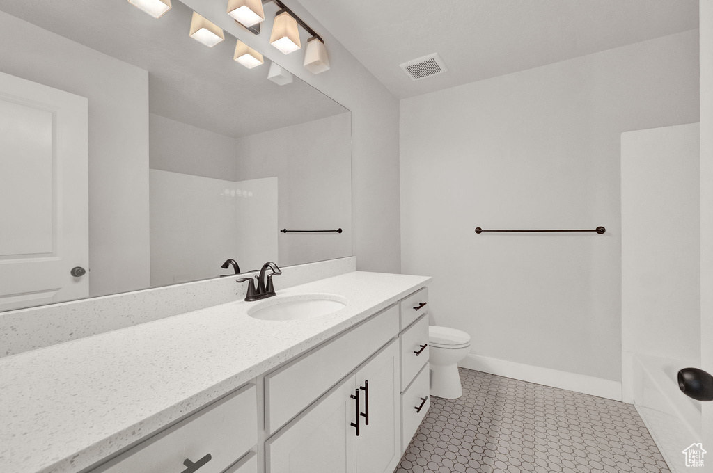 Full bathroom featuring toilet, bathtub / shower combination, tile floors, and vanity