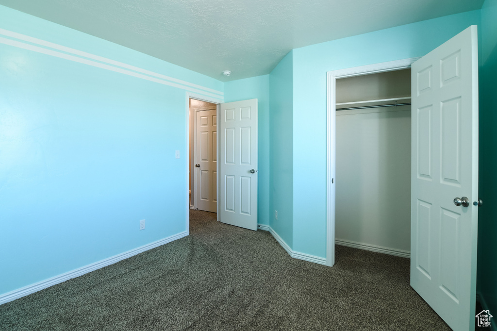 Unfurnished bedroom with a closet and a textured ceiling