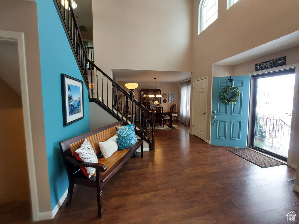 Entryway featuring a notable chandelier, dark hardwood / wood-style floors, and a wealth of natural light