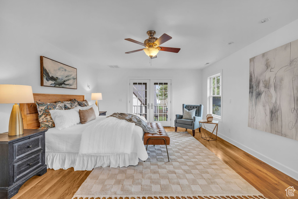 Bedroom with access to exterior, ceiling fan, light hardwood / wood-style flooring, and french doors