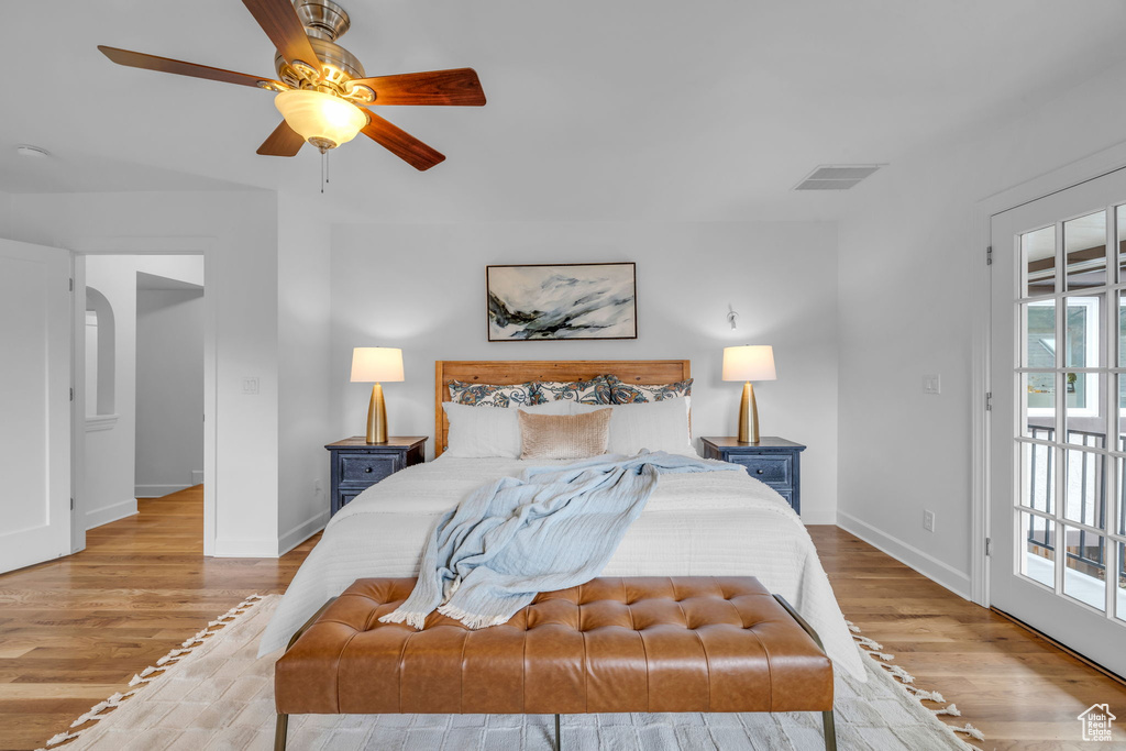 Bedroom featuring multiple windows, light hardwood / wood-style floors, and access to outside