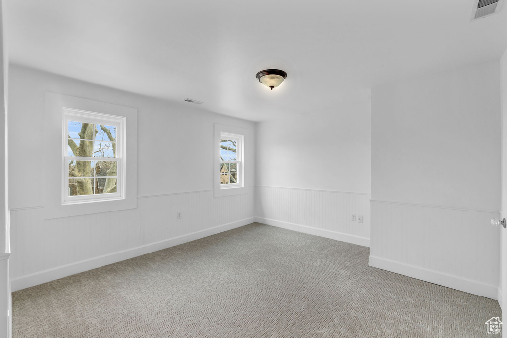 Carpeted spare room with plenty of natural light