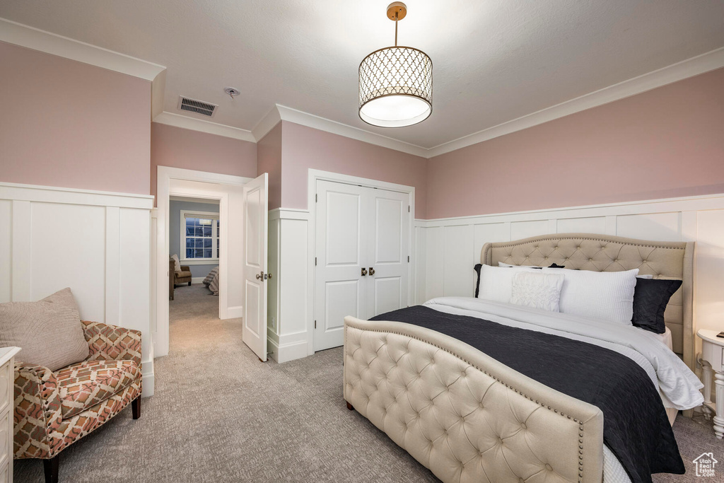 Bedroom featuring crown molding and light colored carpet