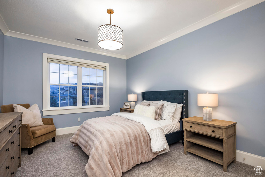Bedroom featuring light carpet and crown molding