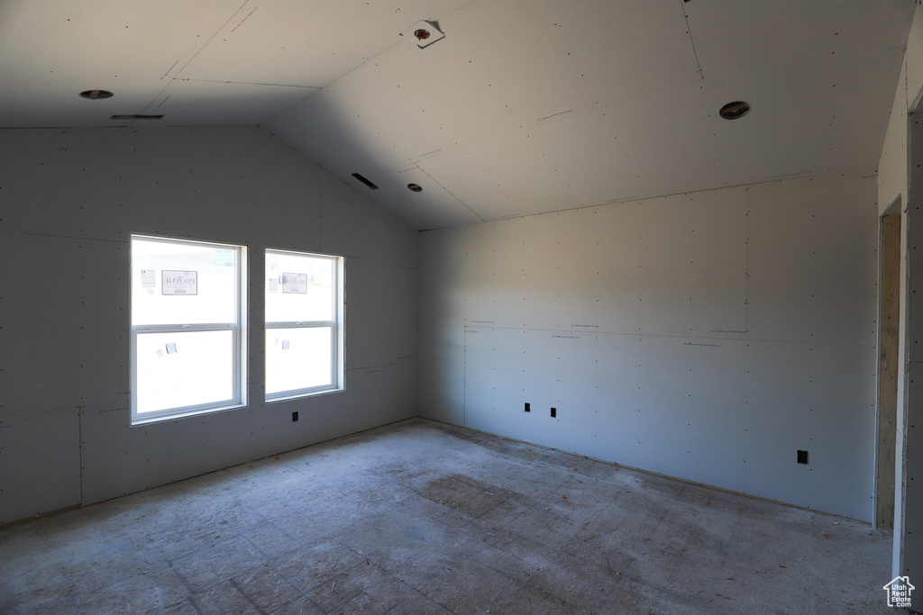 Spare room with lofted ceiling