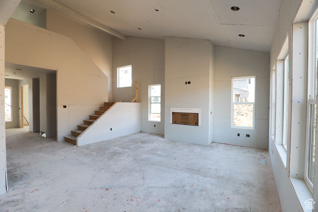 Entryway featuring vaulted ceiling and concrete floors