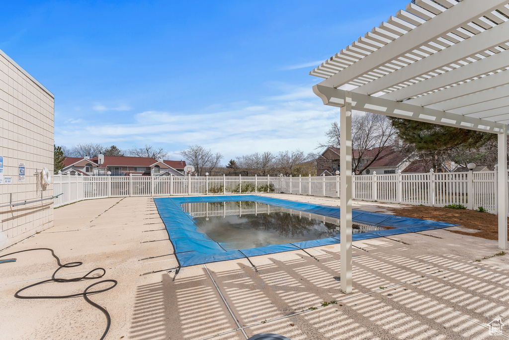 View of swimming pool with a pergola and a patio area