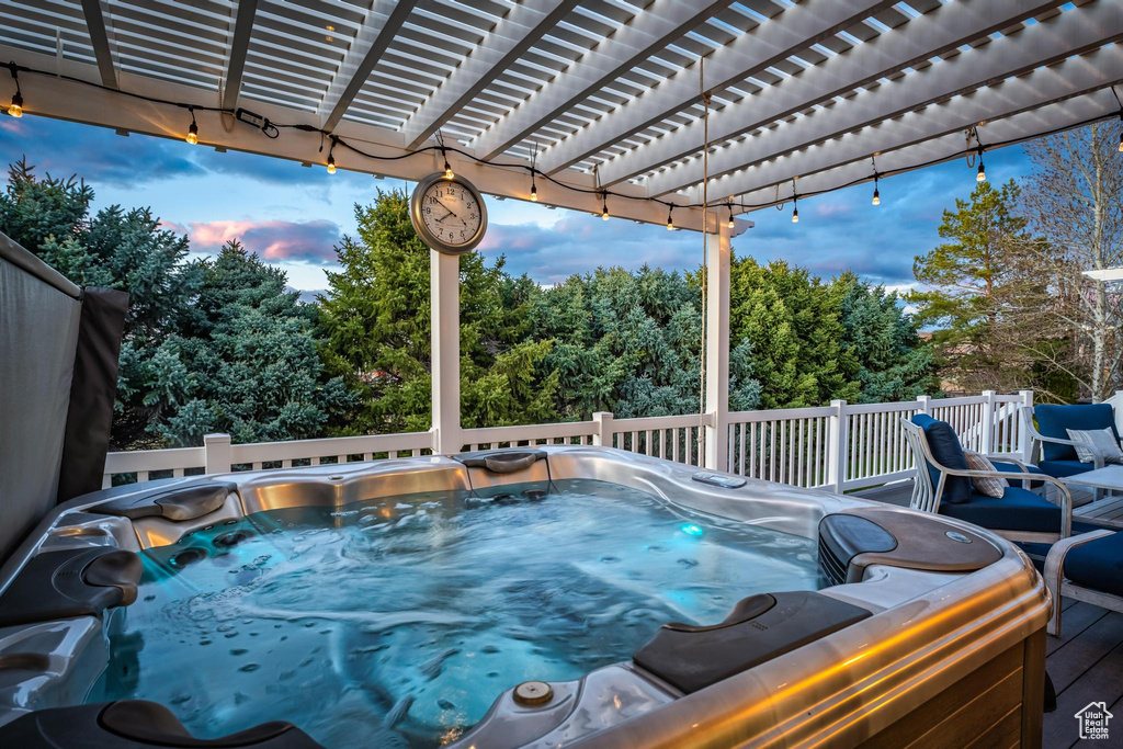 View of swimming pool with a pergola and a hot tub