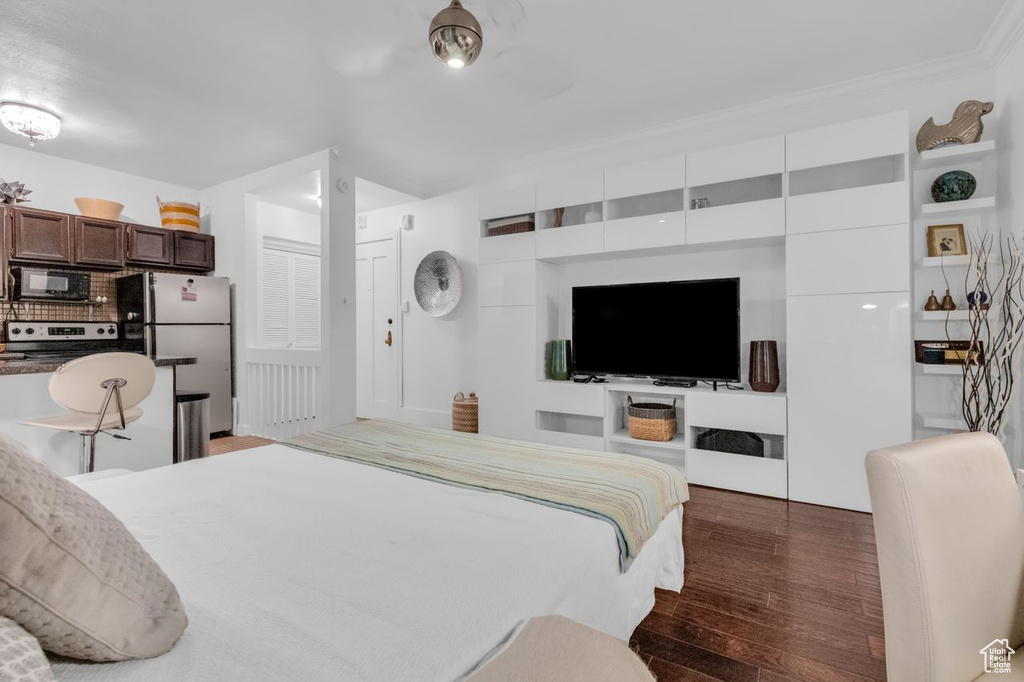 Bedroom featuring dark hardwood / wood-style flooring and fridge