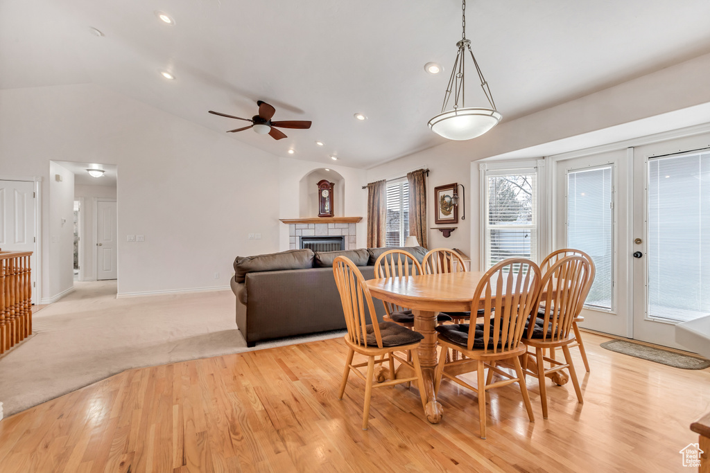Dining space featuring ceiling fan, vaulted ceiling, and light hardwood / wood-style flooring