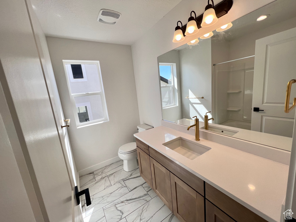 Full bathroom featuring tile floors, large vanity, shower / bathing tub combination, and toilet