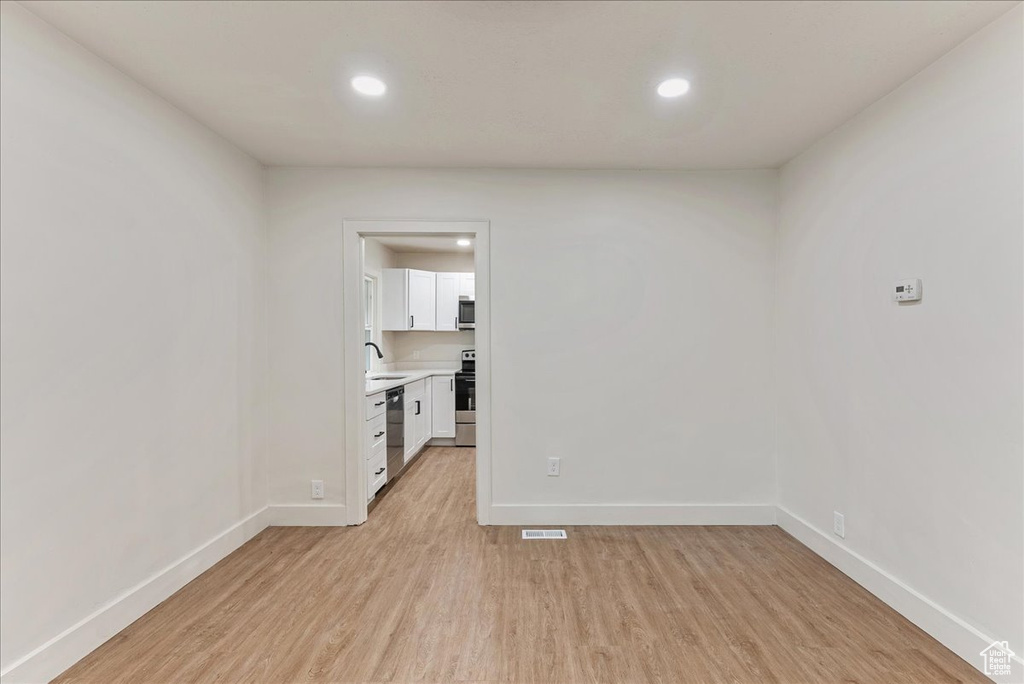 Interior space with light hardwood / wood-style flooring and sink