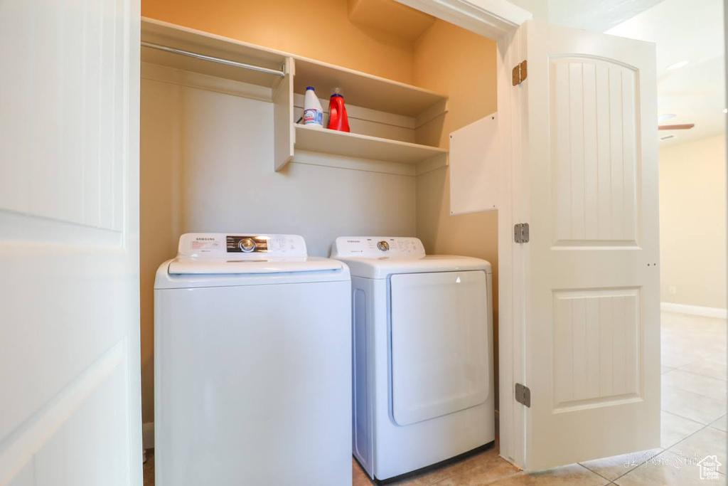 Laundry area with light tile floors and separate washer and dryer
