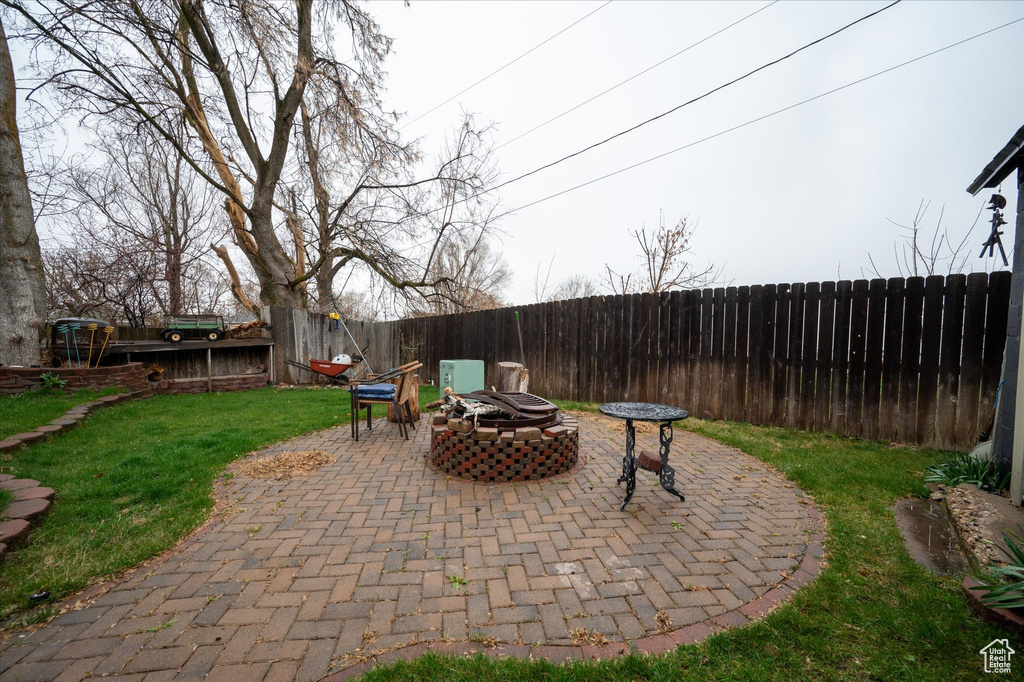 View of patio featuring a fire pit and a trampoline