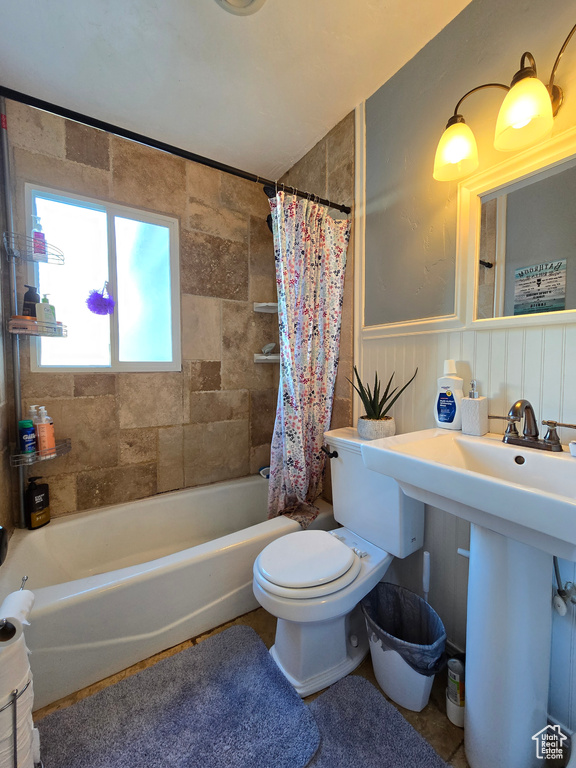 Bathroom with shower / bath combo with shower curtain and toilet