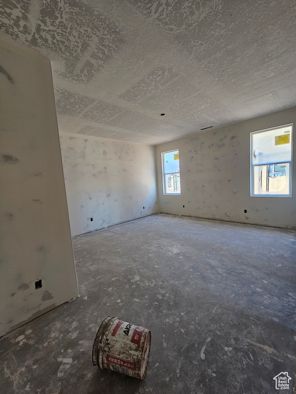 Unfurnished room with a textured ceiling