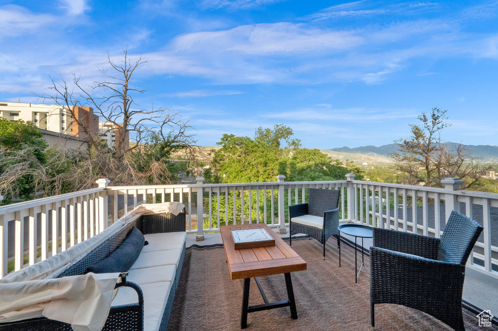 Wooden deck with outdoor lounge area and a mountain view