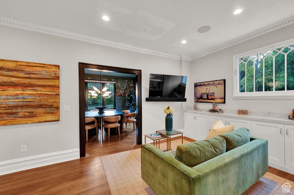 Living room featuring crown molding and light wood-type flooring