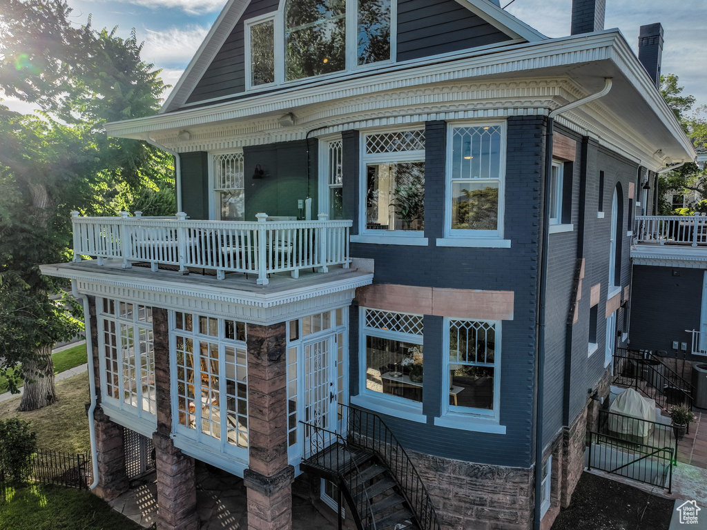 View of home's exterior featuring a balcony and central AC