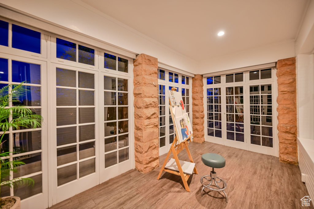 Interior space featuring crown molding and light hardwood / wood-style flooring