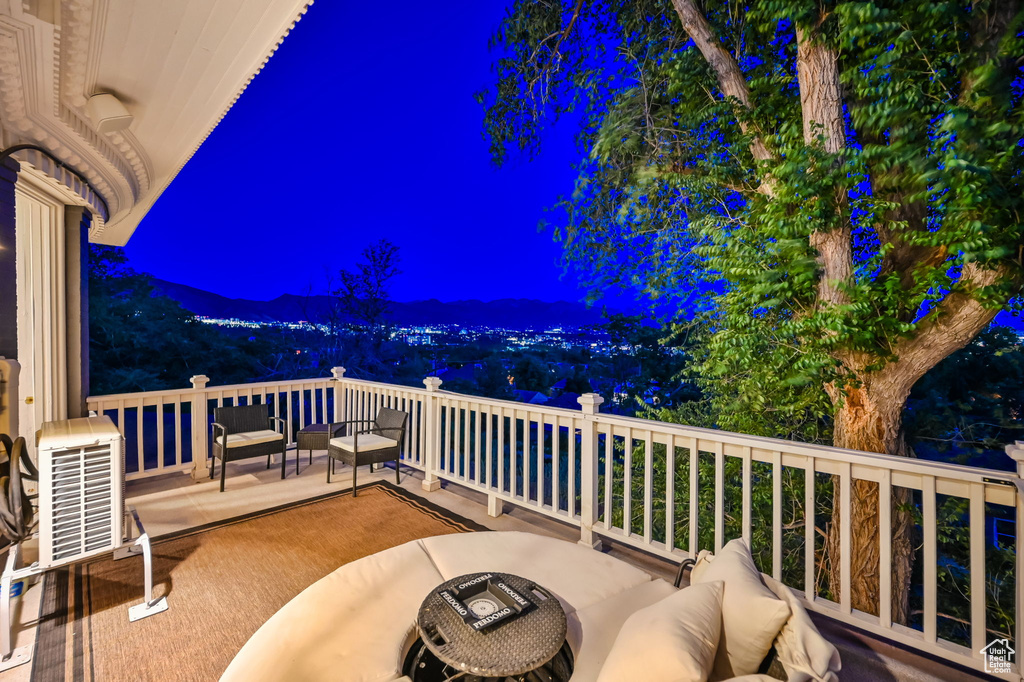 Balcony at twilight with an outdoor hangout area and a mountain view
