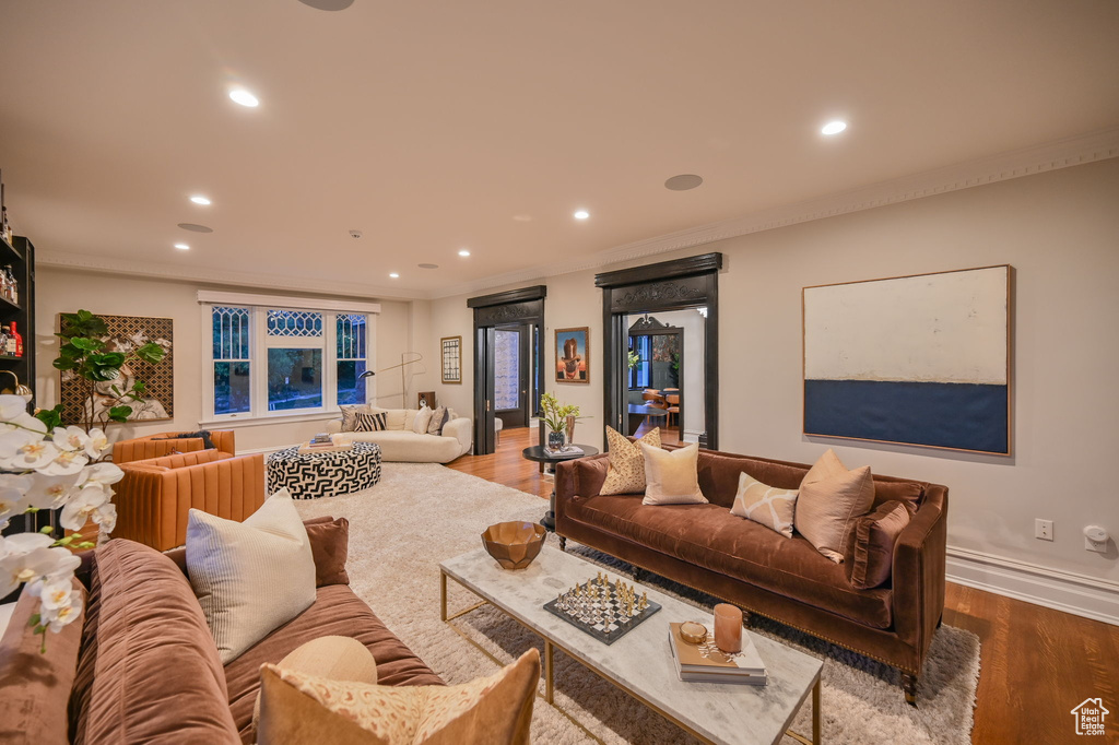 Living room featuring ornamental molding and hardwood / wood-style floors