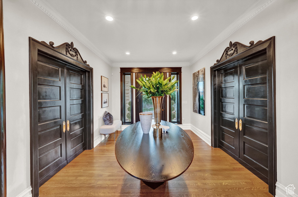 Interior space with ornamental molding and light wood-type flooring