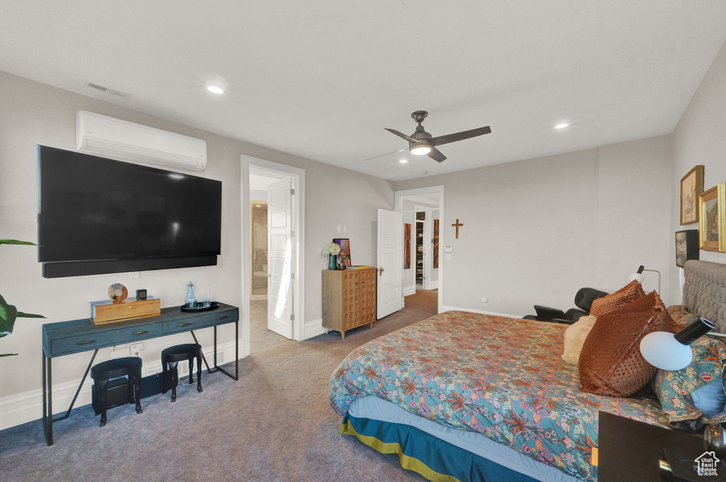 Carpeted bedroom with an AC wall unit and ceiling fan