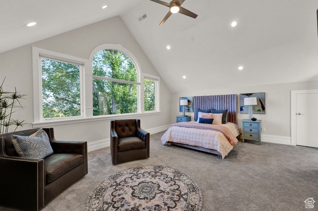 Bedroom featuring multiple windows, ceiling fan, high vaulted ceiling, and light colored carpet