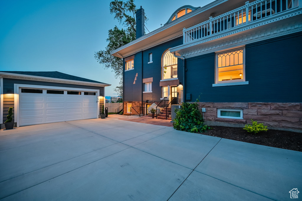 View of front of property with a balcony and a garage