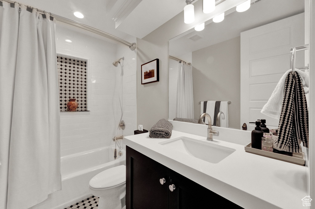Full bathroom with shower / bath combination with curtain, tile floors, toilet, and oversized vanity
