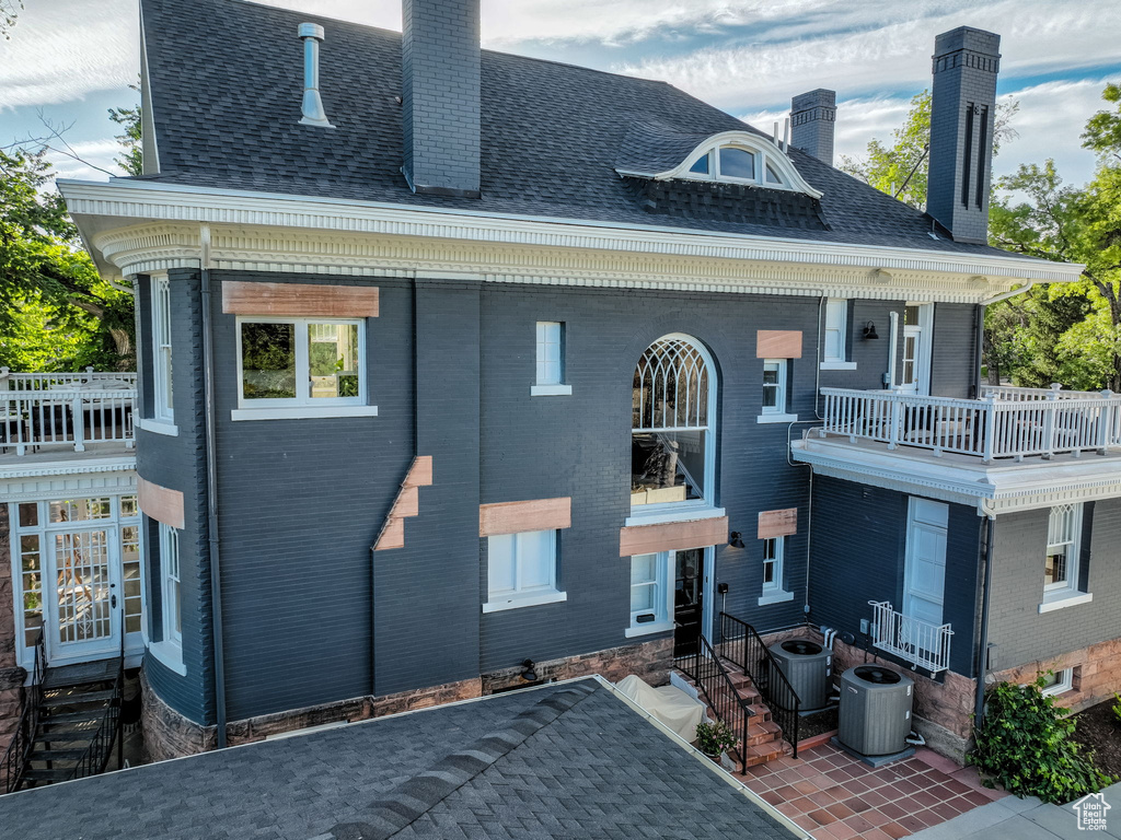 Exterior space featuring a balcony and central AC unit