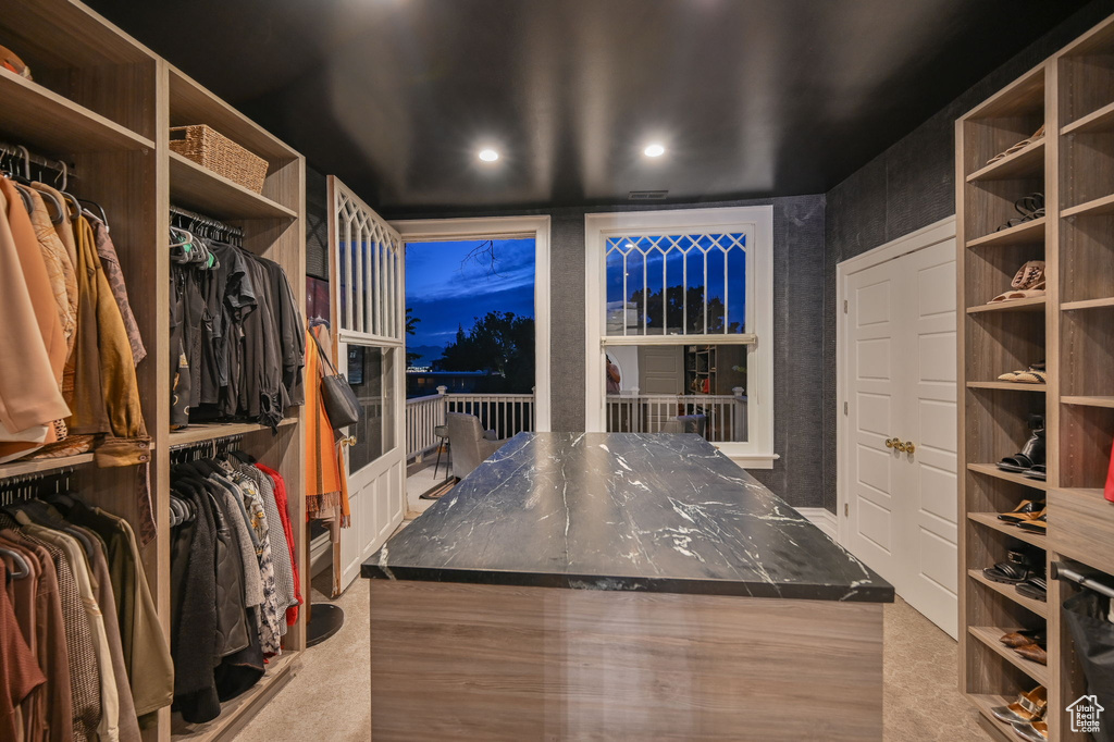 Walk in closet with light carpet