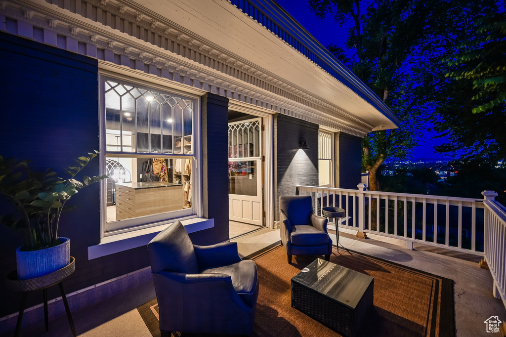 Deck at night featuring an outdoor living space