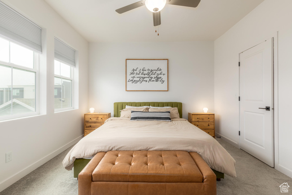 Bedroom featuring light carpet and ceiling fan