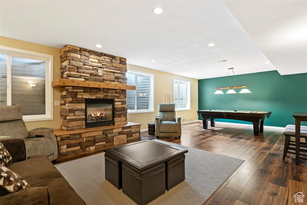 Living room with billiards, a fireplace, and dark hardwood / wood-style flooring