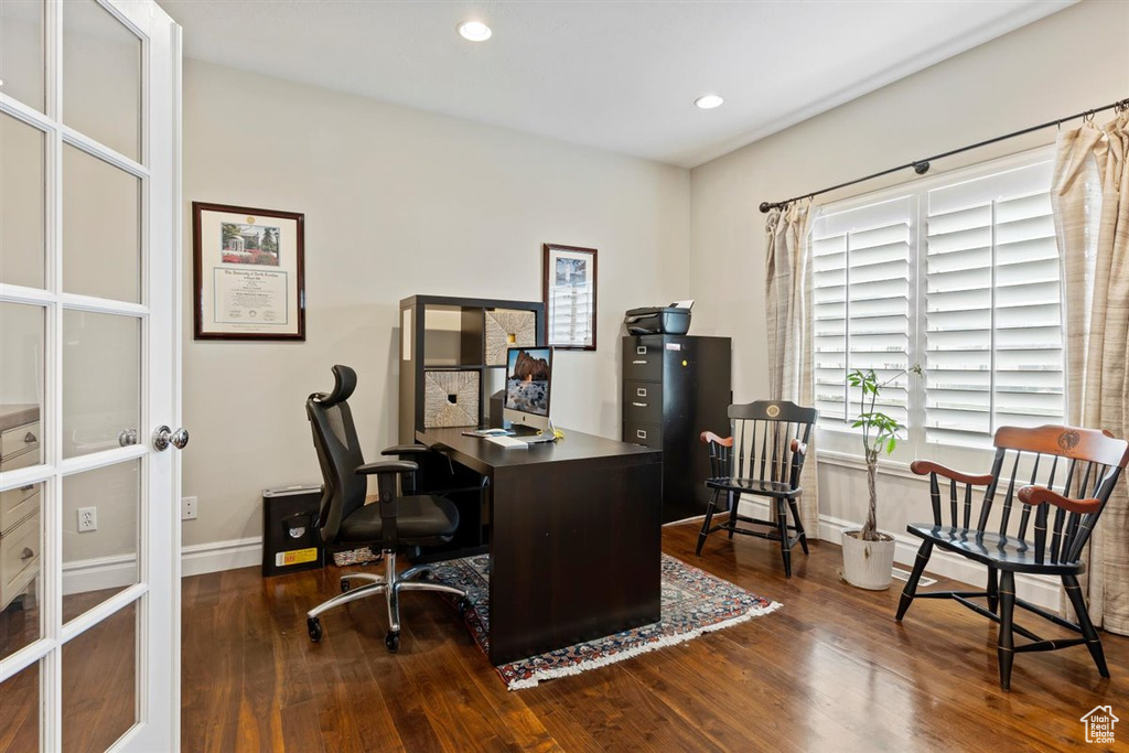 Home office featuring french doors and dark hardwood / wood-style flooring