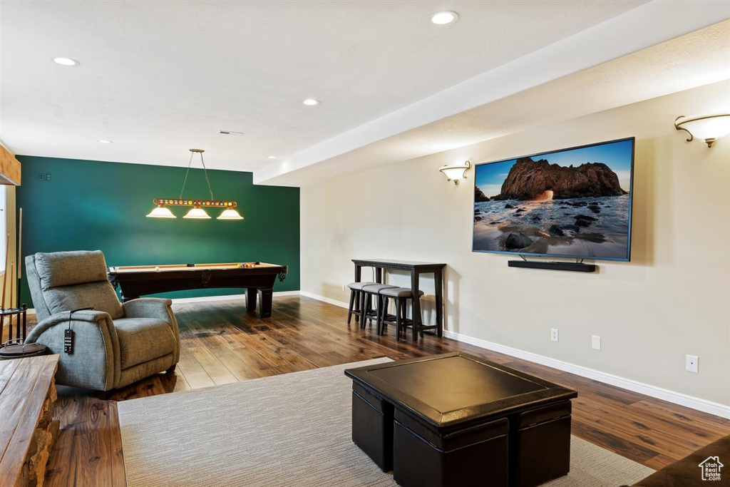 Living room with billiards and dark wood-type flooring