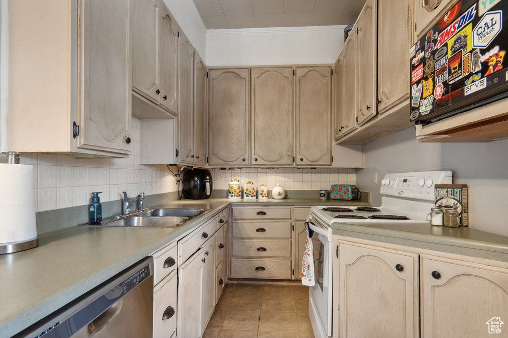 Kitchen with sink, light tile floors, stainless steel dishwasher, white electric range, and tasteful backsplash