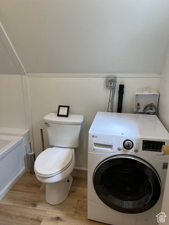Washroom with washer / clothes dryer and light hardwood / wood-style floors