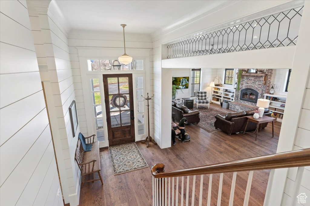 Entrance foyer with hardwood / wood-style floors and a fireplace