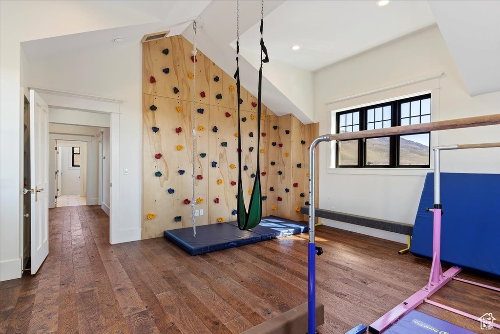 Exercise room with dark hardwood / wood-style flooring