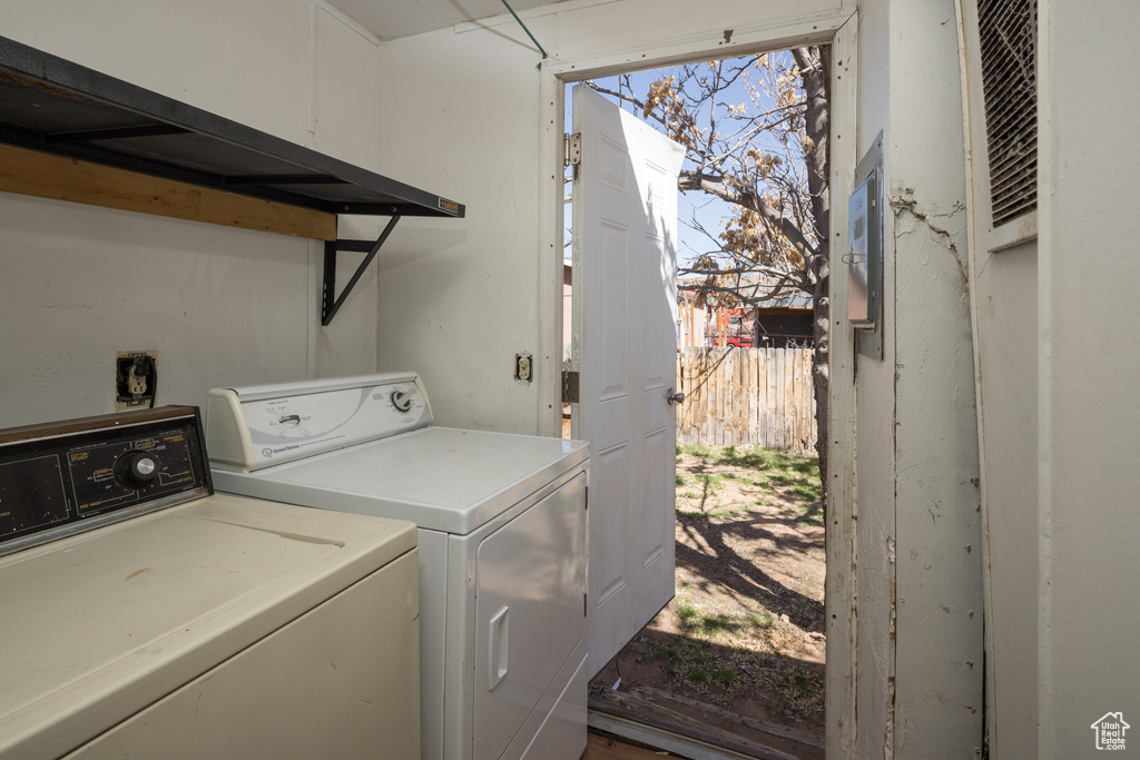 Laundry room with electric dryer hookup, washer and dryer, and a wealth of natural light