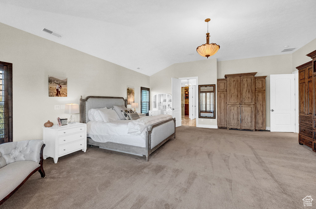 Bedroom with vaulted ceiling and dark colored carpet