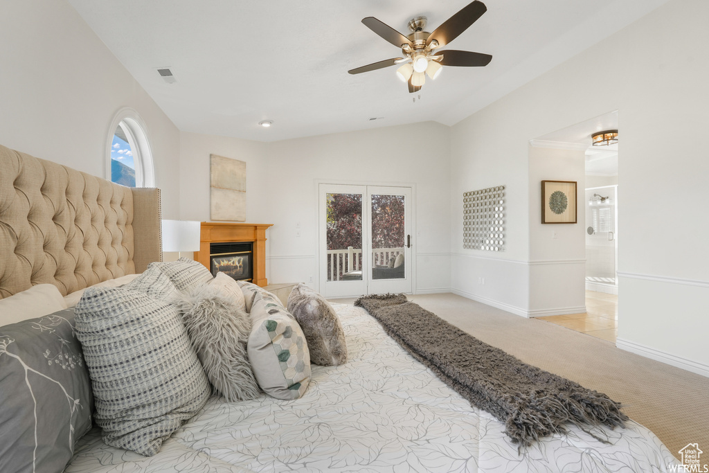 Carpeted bedroom featuring ceiling fan, access to outside, and lofted ceiling