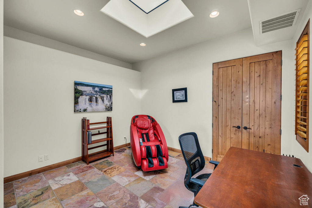 Tiled home office featuring a skylight