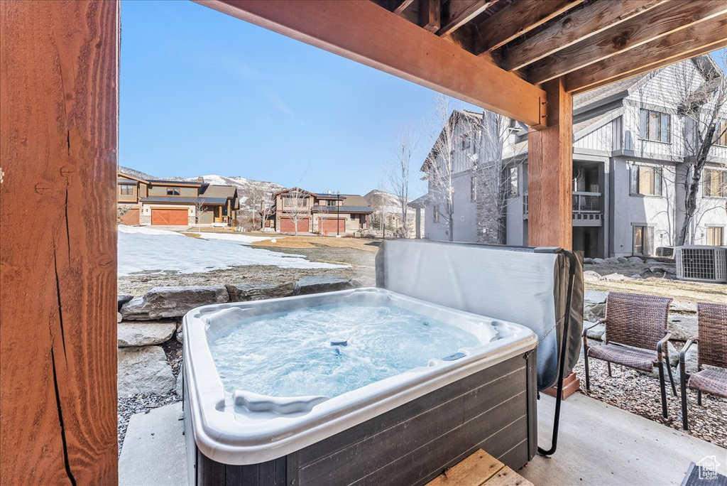 View of patio / terrace featuring a hot tub and central AC unit