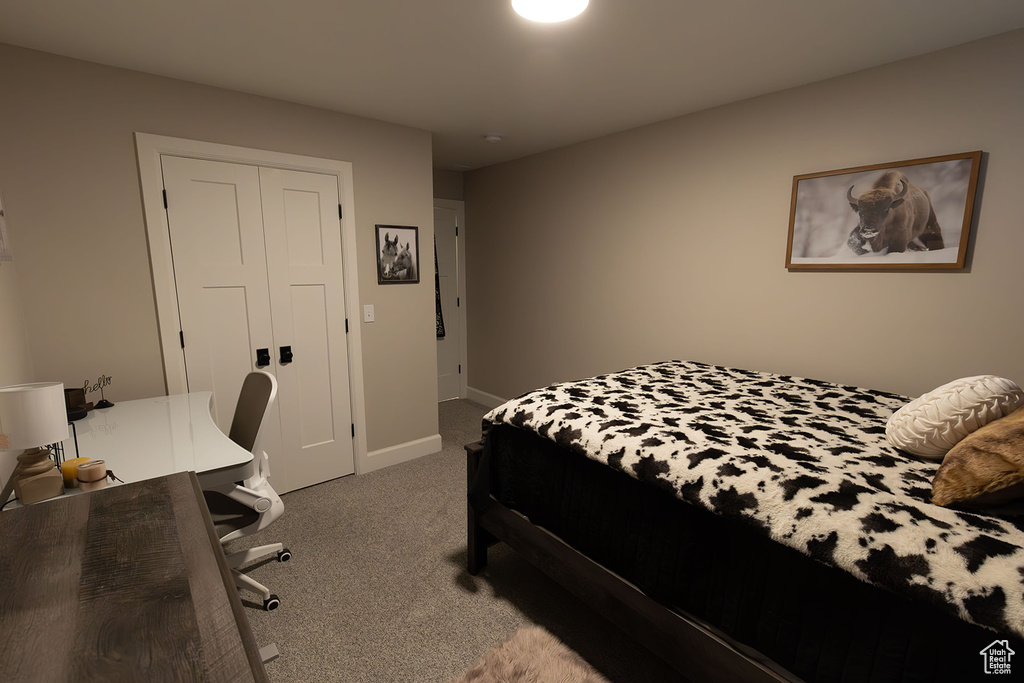 Bedroom featuring a closet and dark colored carpet