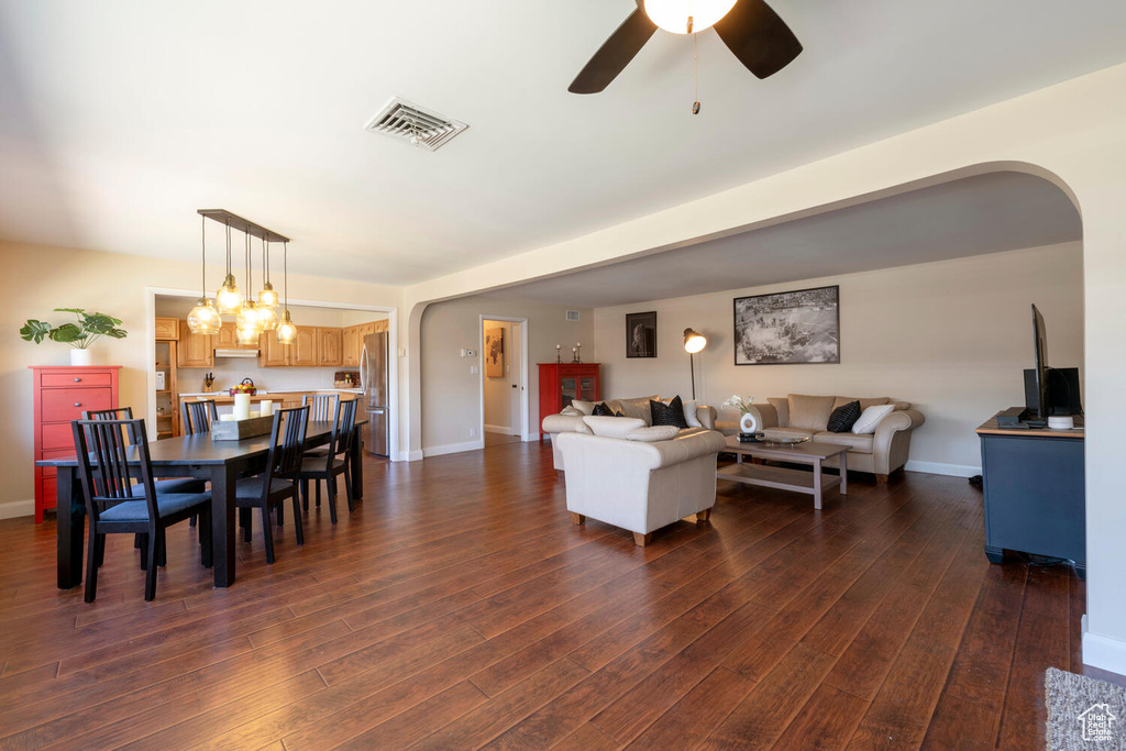 Living room featuring dark hardwood / wood-style floors and ceiling fan with notable chandelier